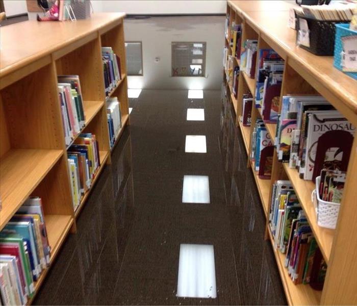 Standing water on the carpet floor of a library