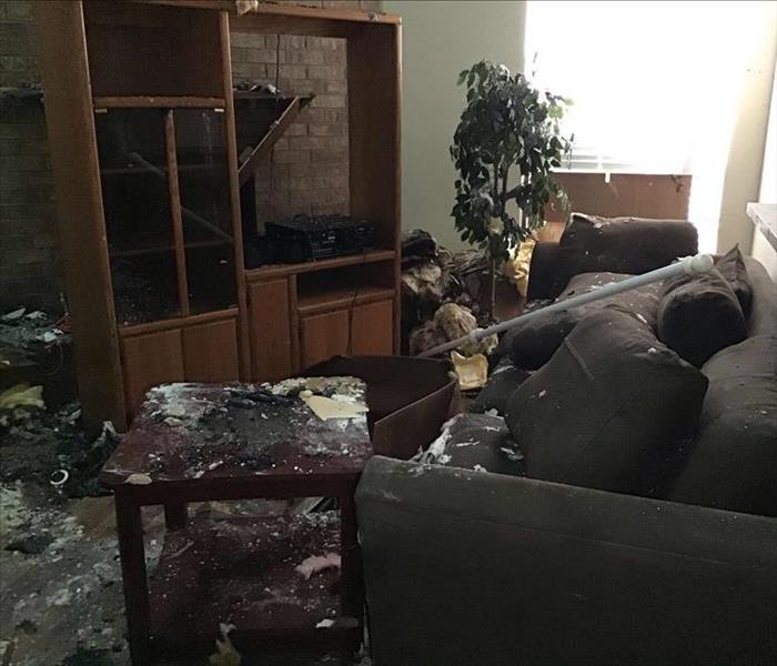 Living room with Couch and TV stand covered in insulation