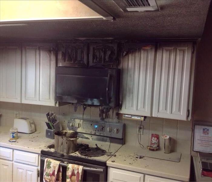 Kitchen burned above stove with soot on walls