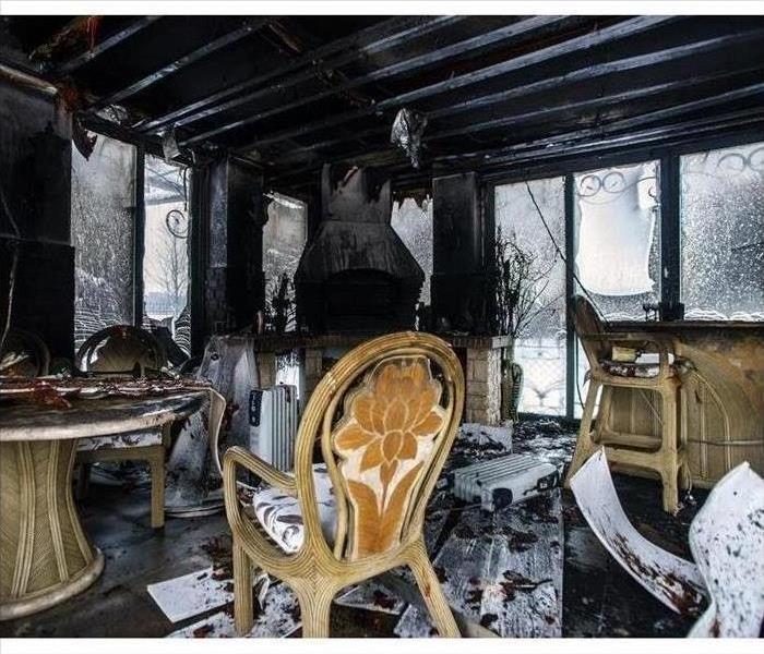 Burned house with chair in the forefront