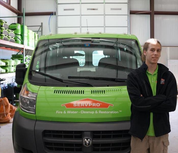 One of our owners, Bailey Stone, standing in front of our van