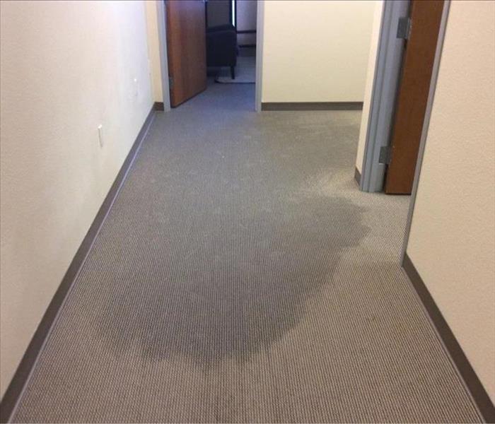 Soaked carpet in the offices of a church from a water heater