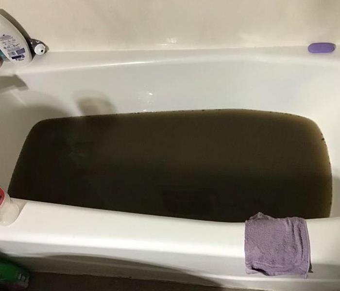 Water drainage backup into bathtub